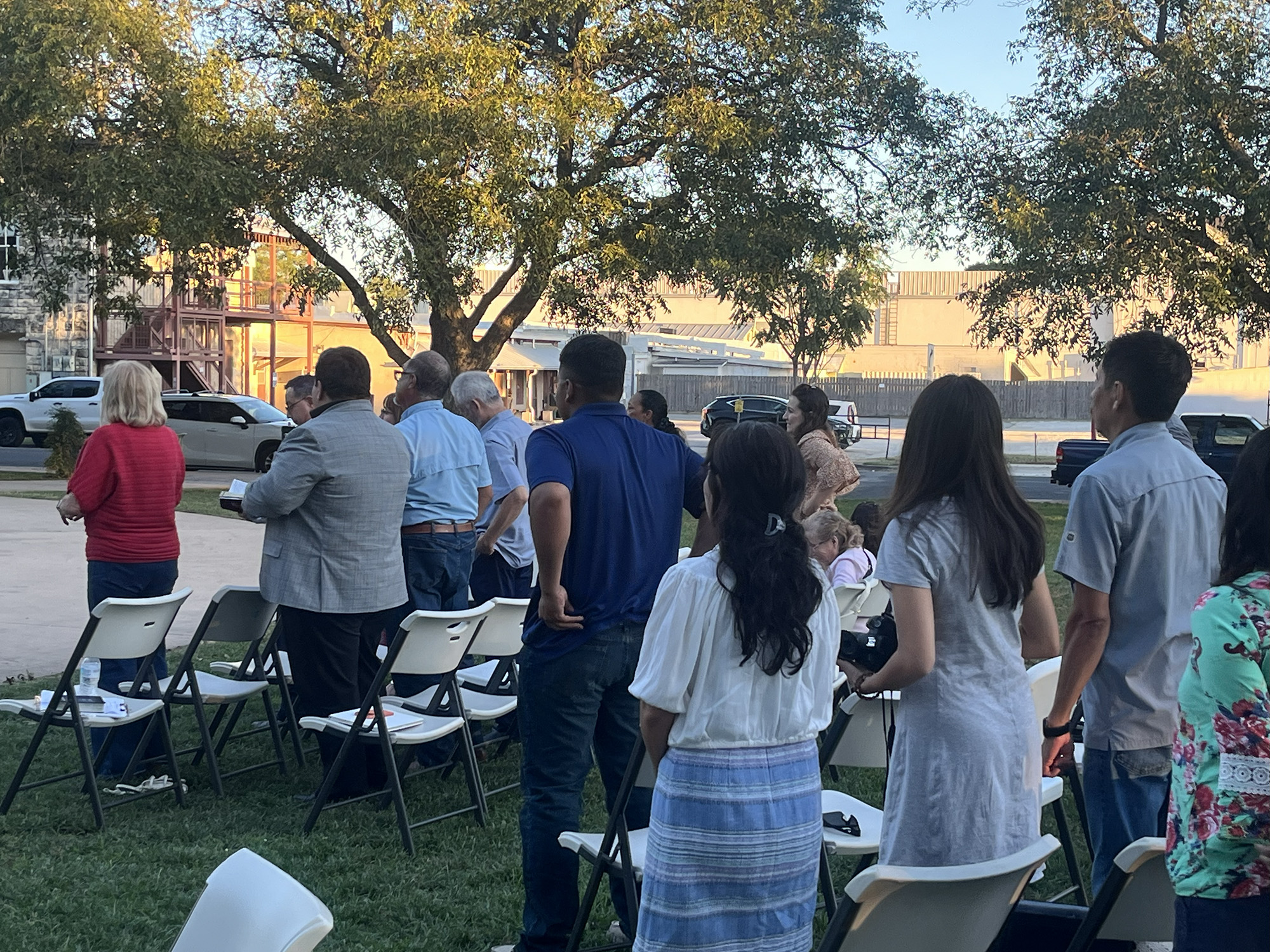 Attendees rise to pray and worship