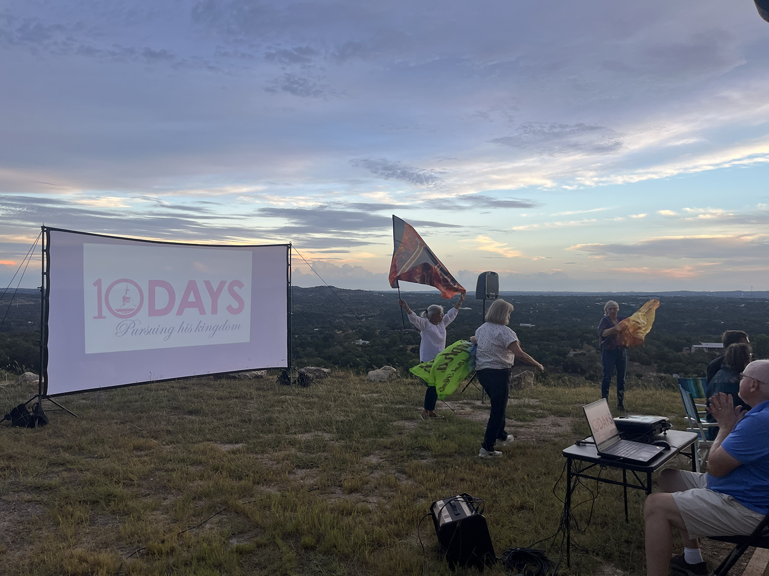 Ladies worship with flags of glory to the god of our redemption