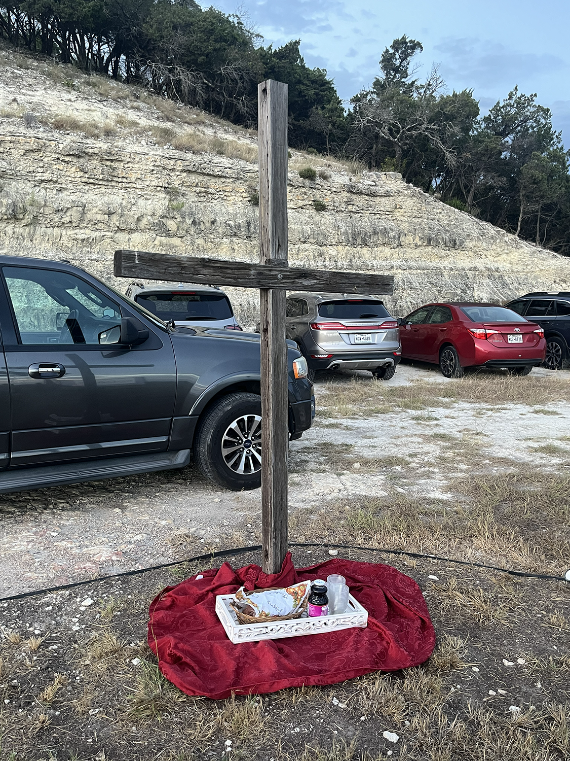 The elements of remembrance wait at the foot of the cross