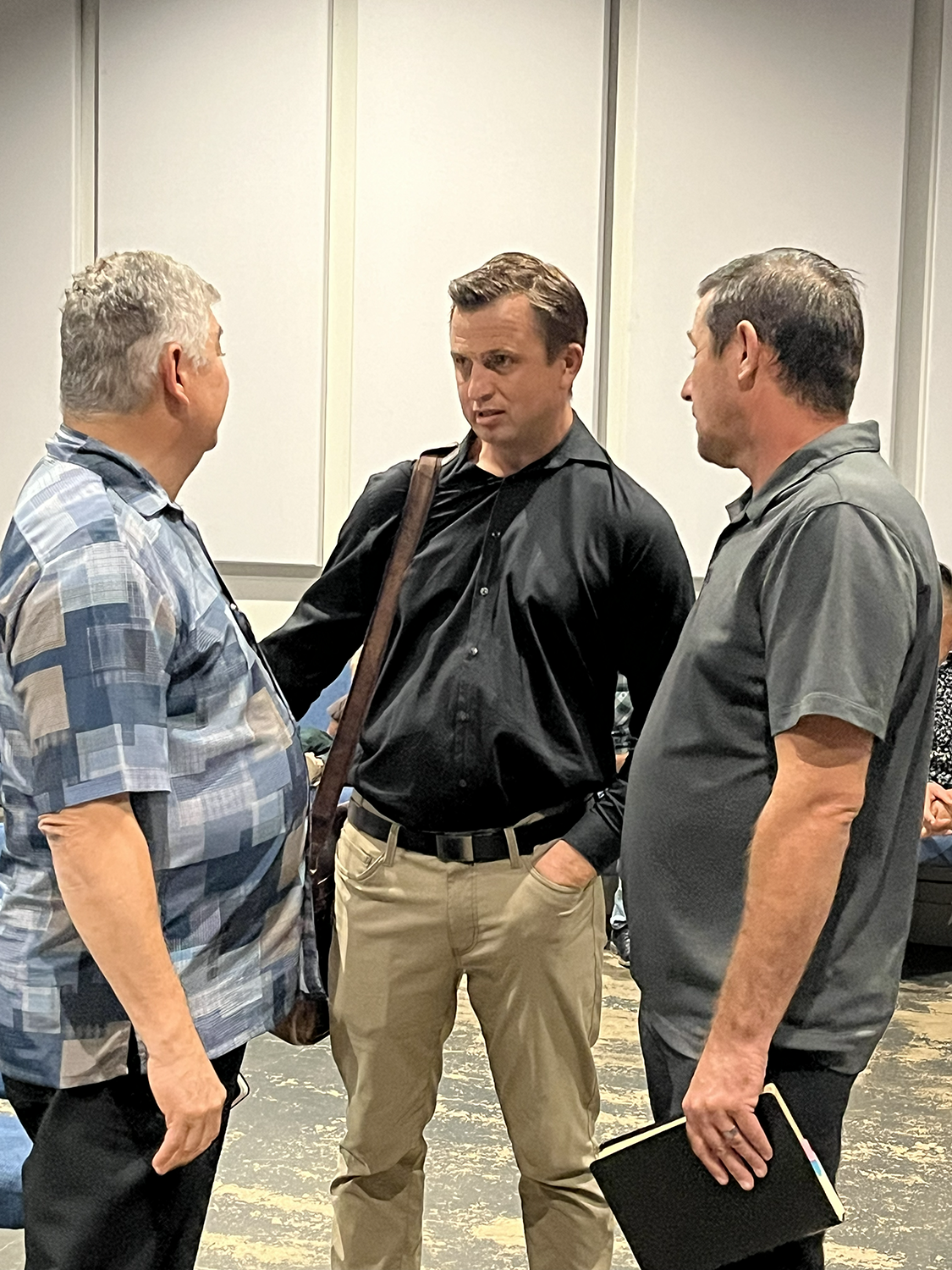 Pastor Ruben Martinez confers with pastors of God Will Provide Church